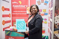 Tabitha celebrating becoming a finalist in the World Food Innovation Awards 2025 at her stand at the International Food and Drink Event