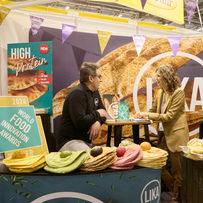 Lika Bakery at the International Food and Drink Event, IFE, in 2024 with their World Food Innovation Awards logos and trophy